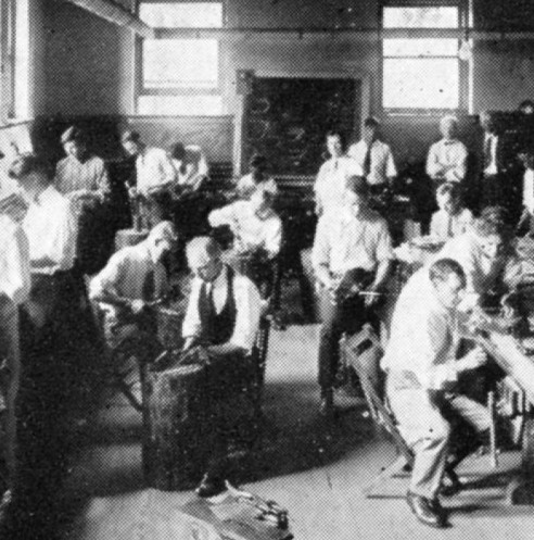 image showing a class of students in the late afternoon sun working in a metalsmith shop
