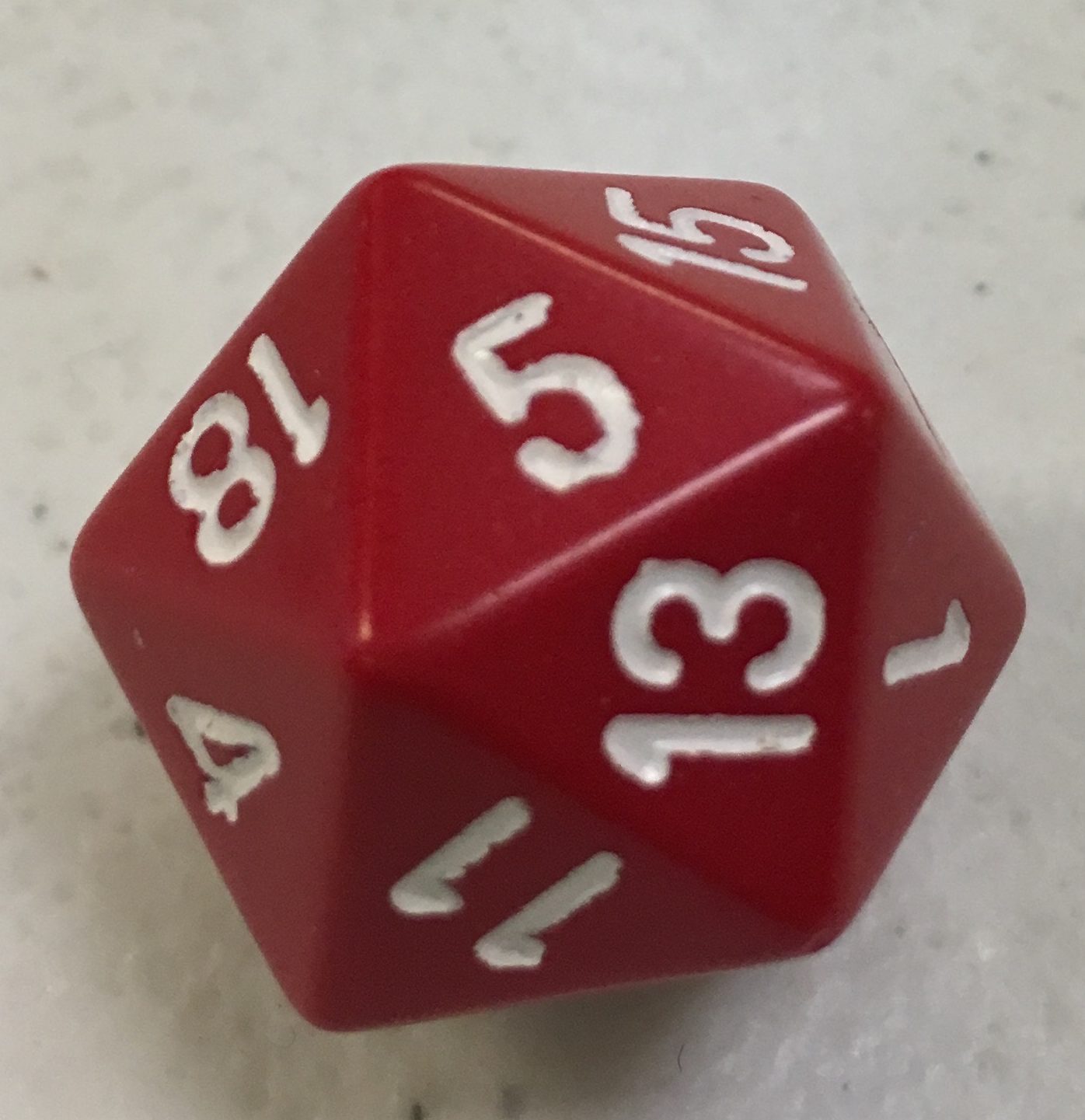 A color photo of a red twenty-sided die