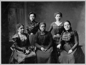 A black and white photo showing five African American women