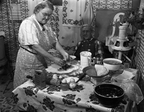 A woman making pasties in a black and white photo