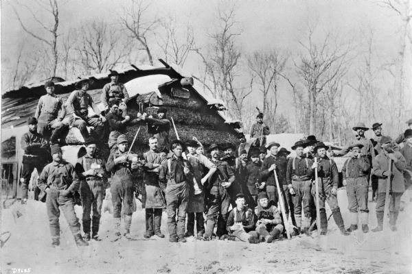 lumberjacks posing with the tools of their trade