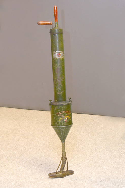image of a green hand-powered vacuum