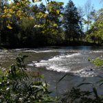 an image of a triangle shaped fishing weir in a river