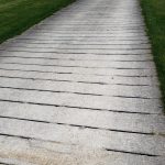 A plank road across a grass field