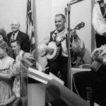 A man plays the banjo at a polka party in 1957 in Verona